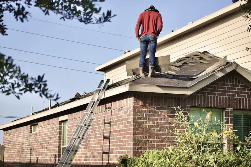Professional roofer working on a residential roof in Hadlyme